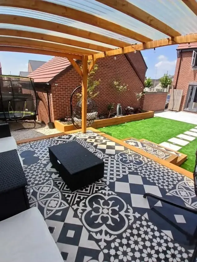 Pergola with patterned porcelain tiles and lawn – The Green Team, Shropshire
