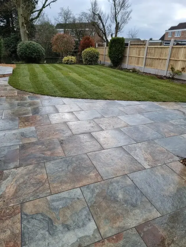 Slate patio with curved lawn edge – The Green Team, Shropshire