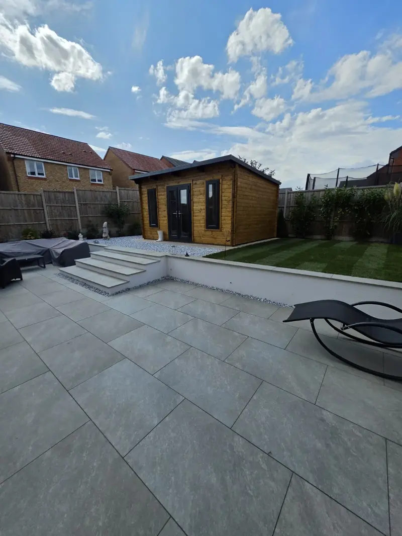 Grey porcelain patio, steps and raised lawn completed by The Green Team in Shropshire