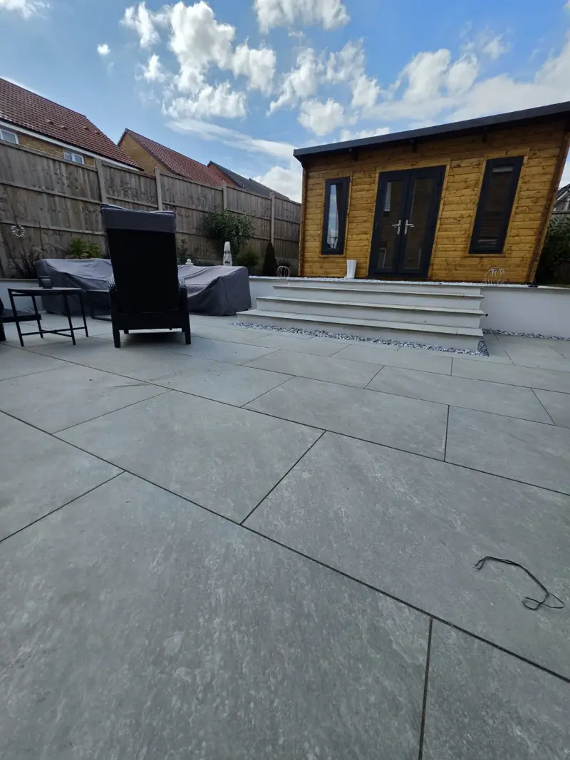 Grey porcelain paving and wide garden steps by The Green Team